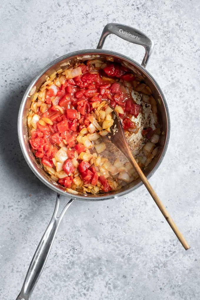 tomatoes added to pot with sautéd aromatics and spices