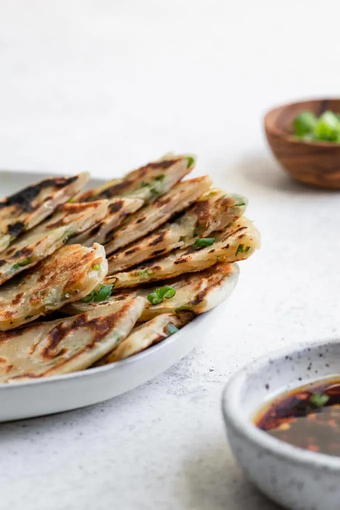 side view of scallion pancakes cut into wedges to show layers