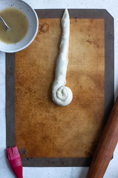 a half rolled spiral of dough