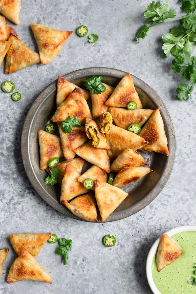 baked samosa served with a cilantro mint chutney