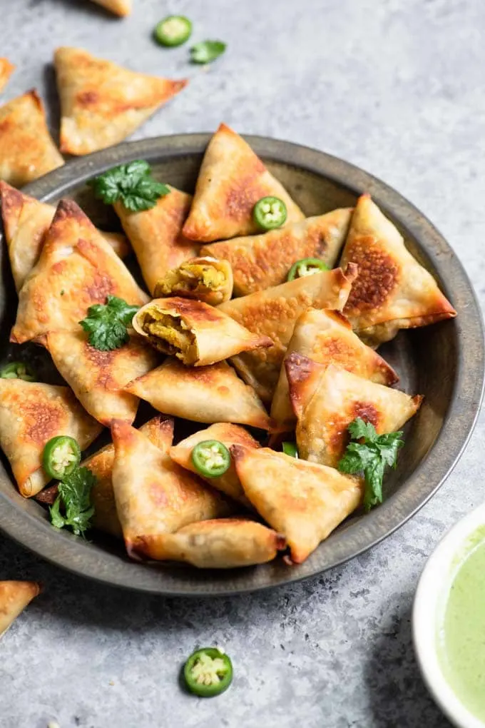 baked samosa garnished with cilantro and chili