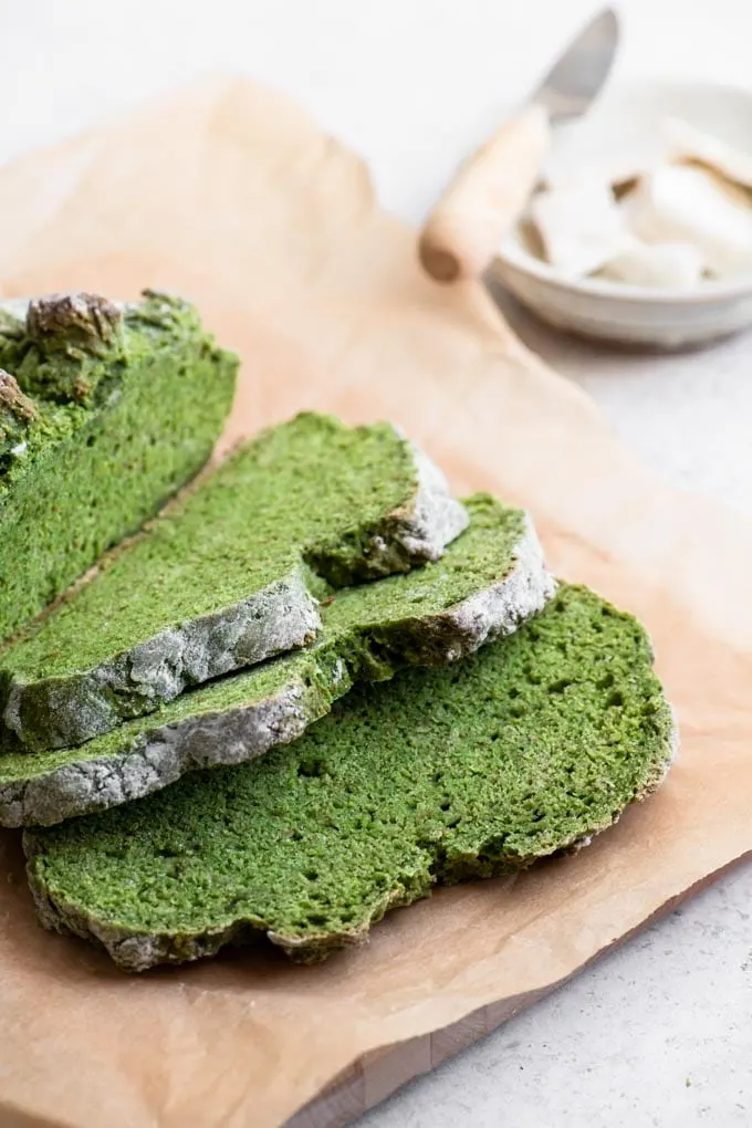 sliced green soda bread with a bowl of butter