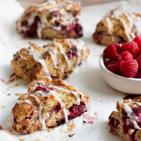 side view of raspberry scones on a baking tray
