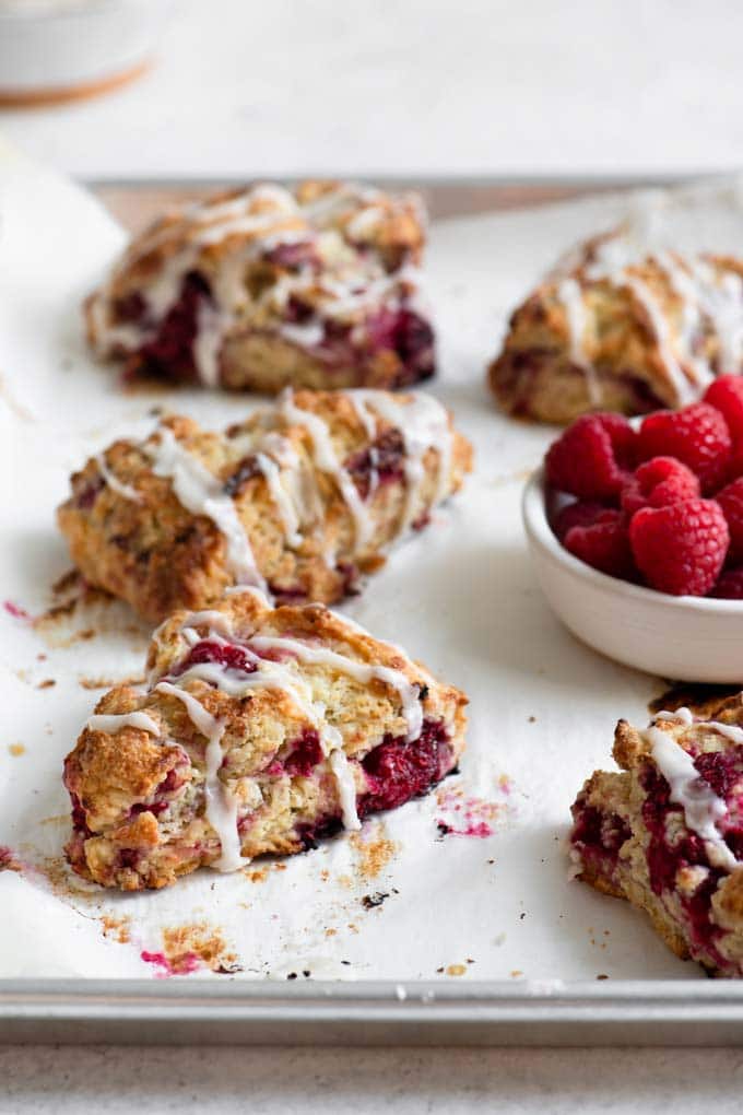 side view of raspberry scones on a baking tray