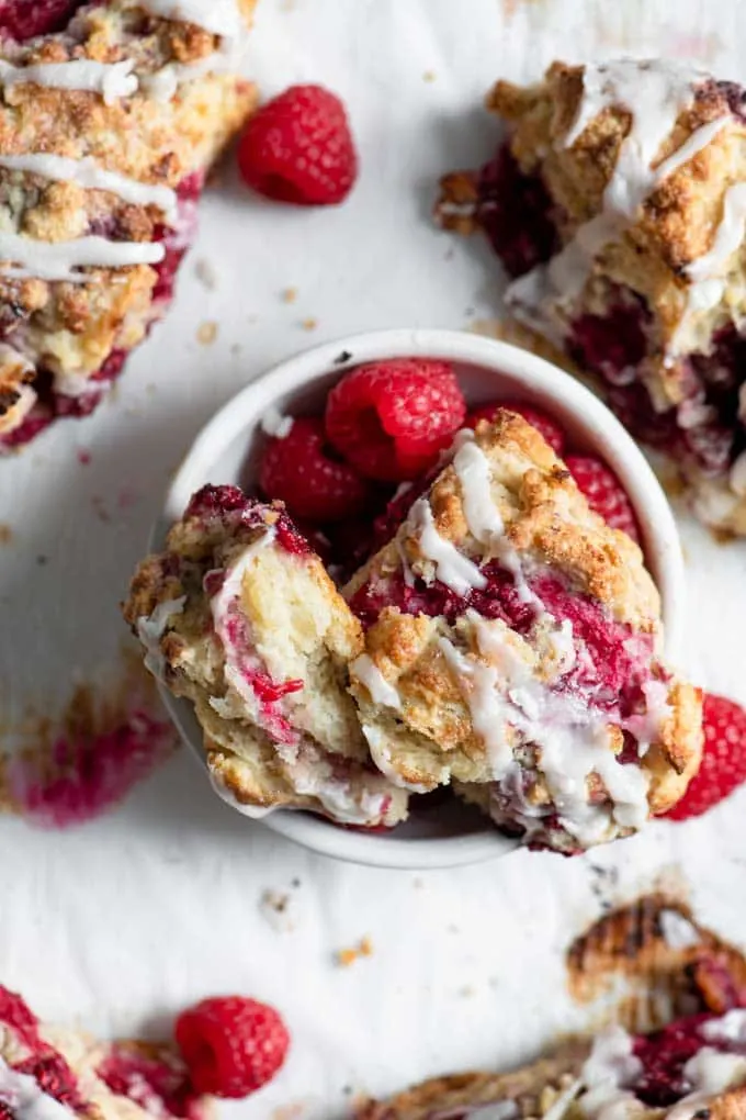 pieces of scone in a bowl with raspberries