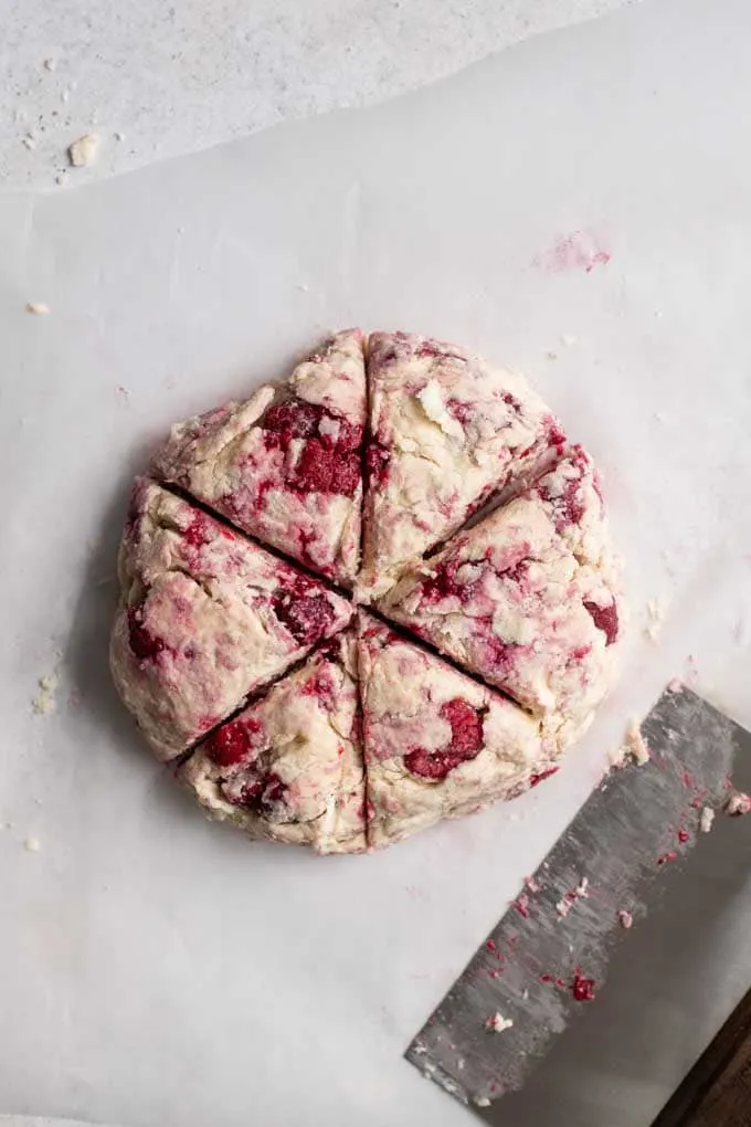 raspberry scone dough cut into triangles