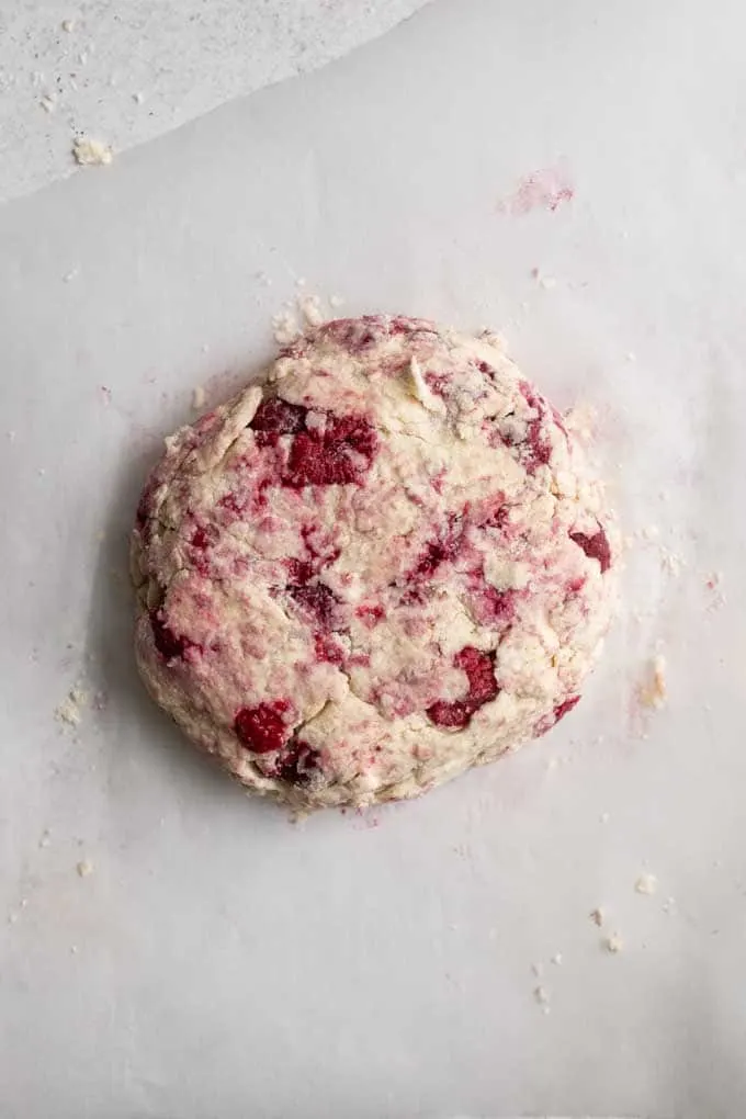 raspberry scones shaped into disk to cut