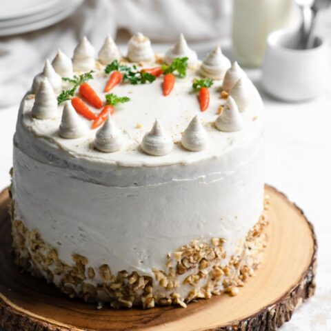 carrot cake decorated with vegan cream cheese frosting