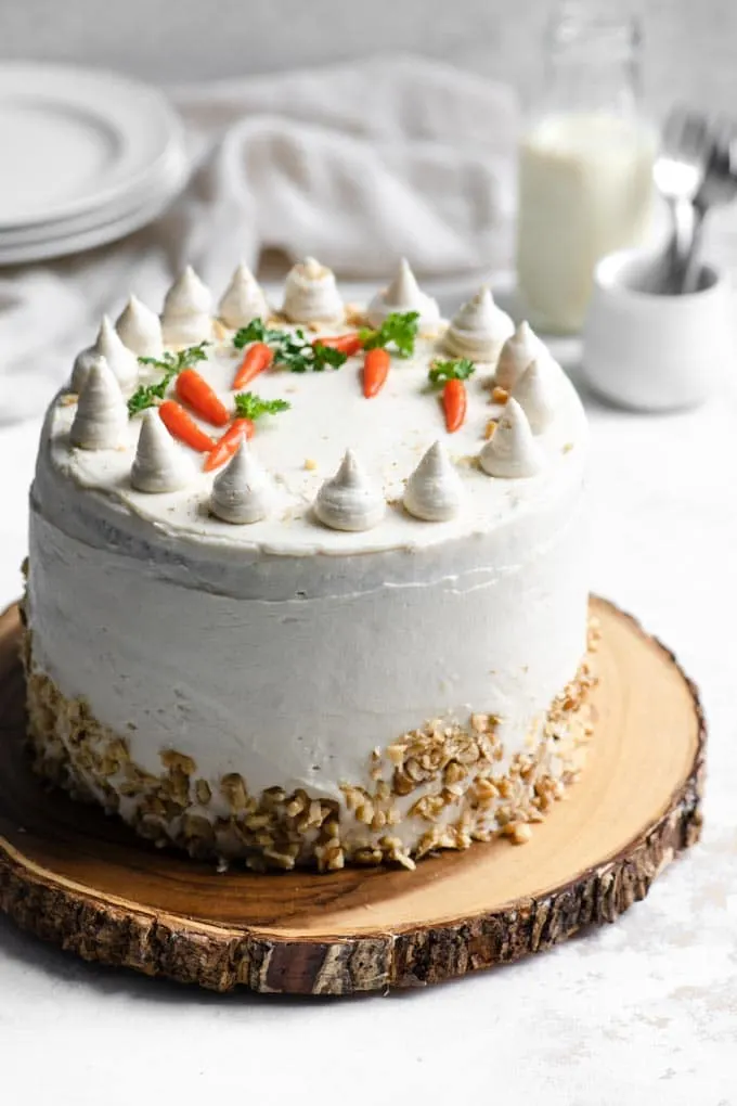carrot cake decorated with vegan cream cheese frosting