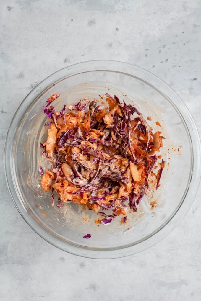 kimchi slaw mixed together in mixing bowl