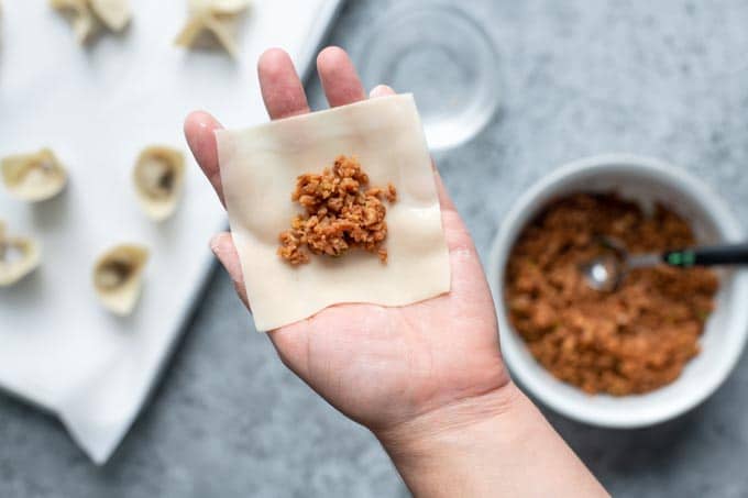 dumpling wonton shape folding step 1: wet half of the wrapper edges