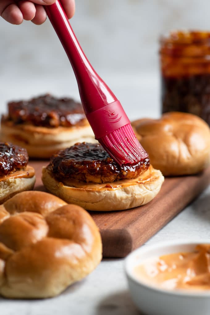 brushing korean BBQ glaze on burgers