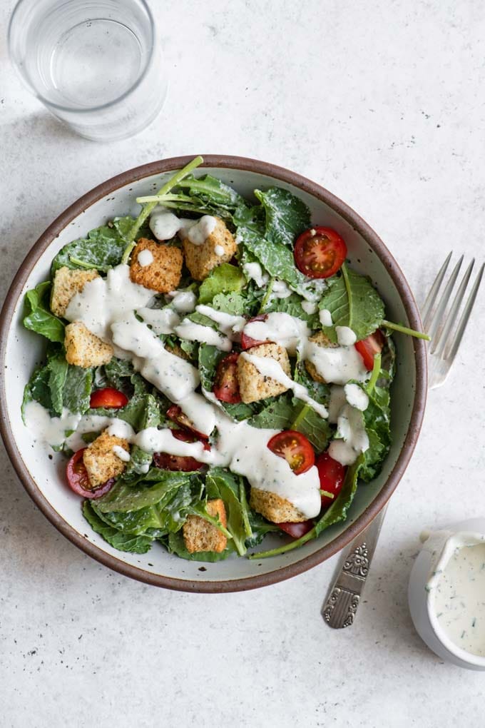salad with croutons, cherry tomatoes, and a drizzle of cashew ranch dressing