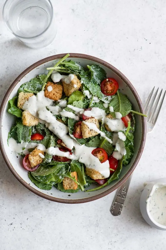 salad with croutons, cherry tomatoes, and a drizzle of cashew ranch dressing