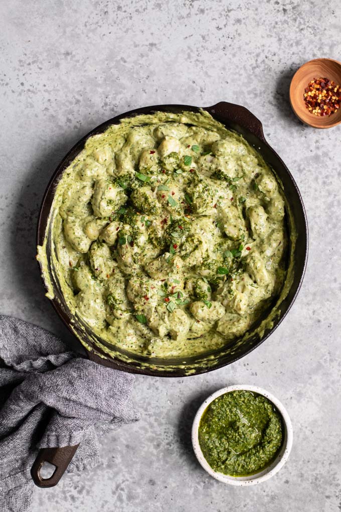 pesto cream gnocchi in cast iron skillet