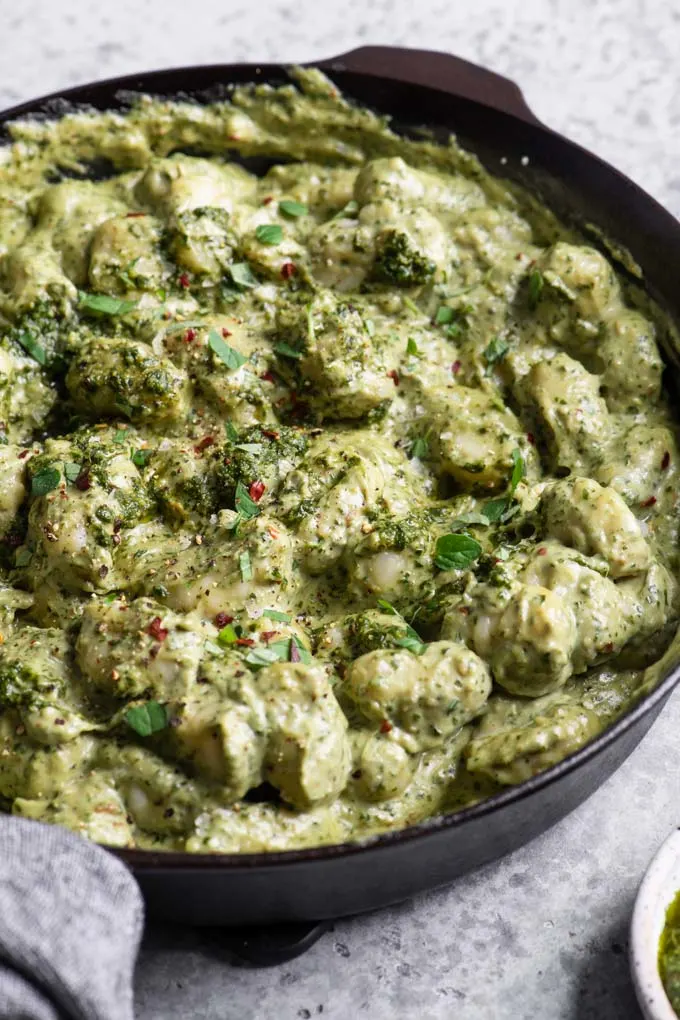 vegan pesto cream gnocchi in cast iron skillet