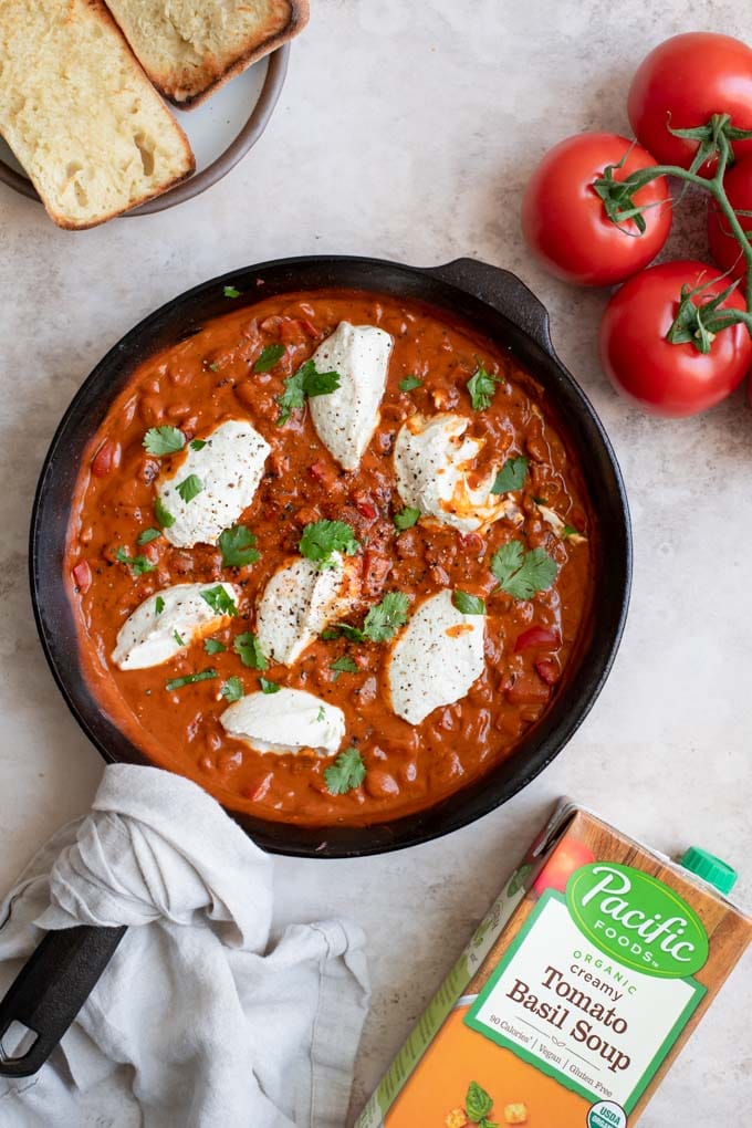 shakshuka with vegan ricotta in a cast iron skillet served with toast