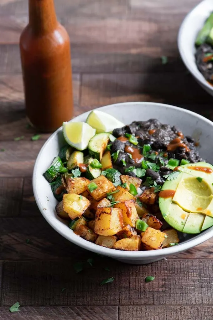black bean bowl served with hot sauce