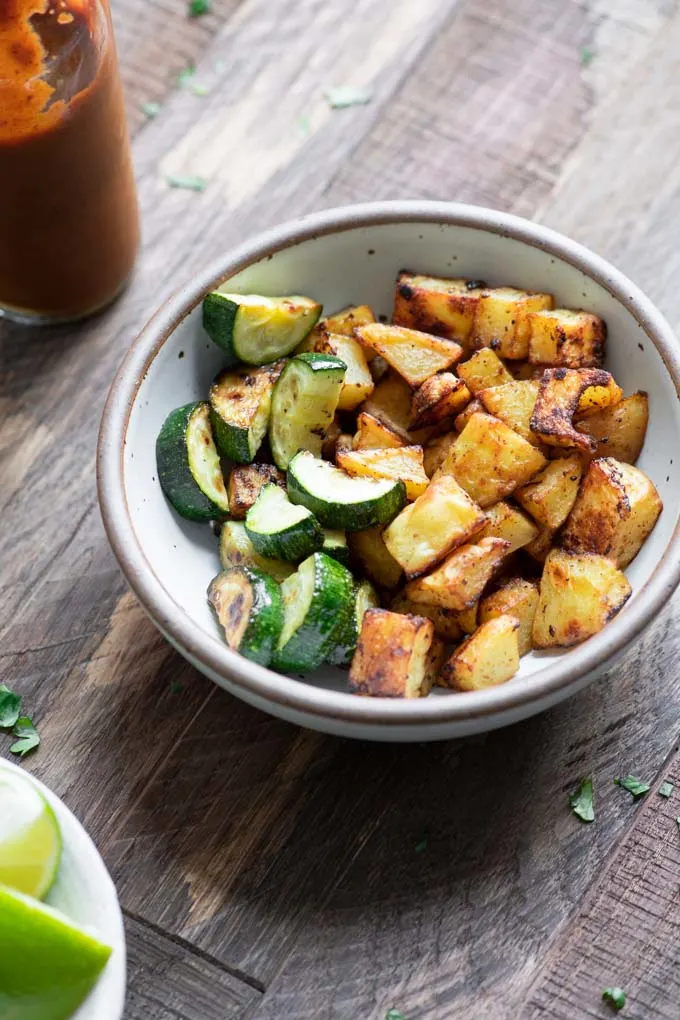 roasted potato and pan fried zucchini in a bowl