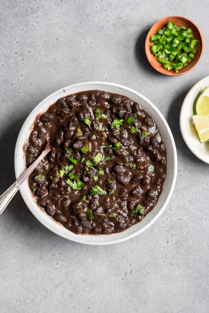 beans in bowl with cilantro and jalapeño garnish