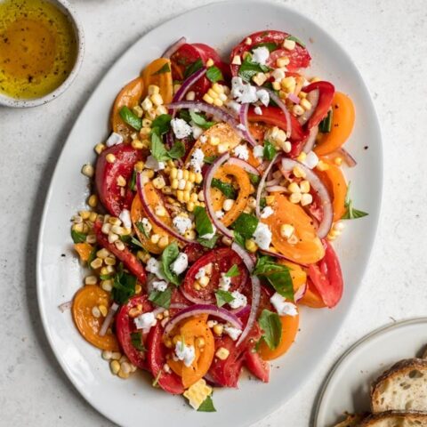 fresh tomato sweet corn salad served on oval plate