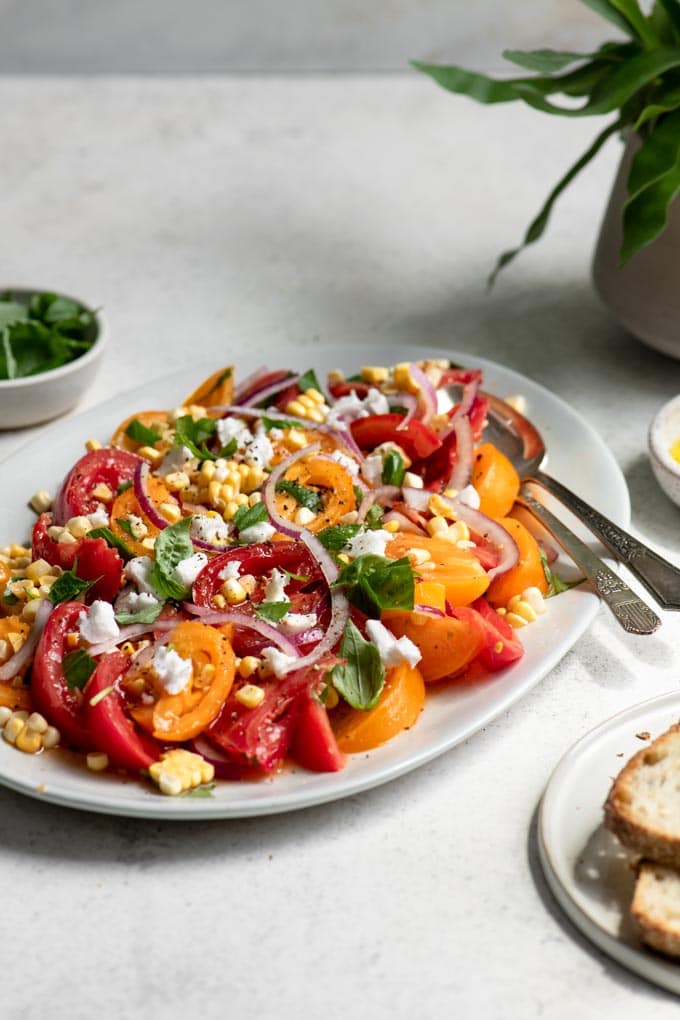 tomato corn salad served with a side of bread