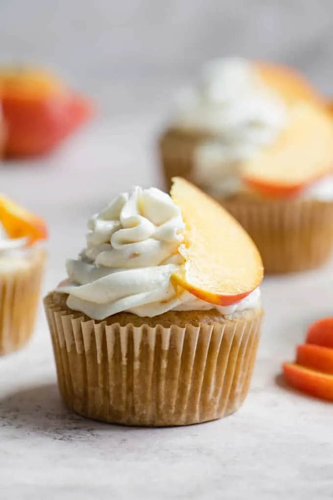 close up of a single peach cupcake