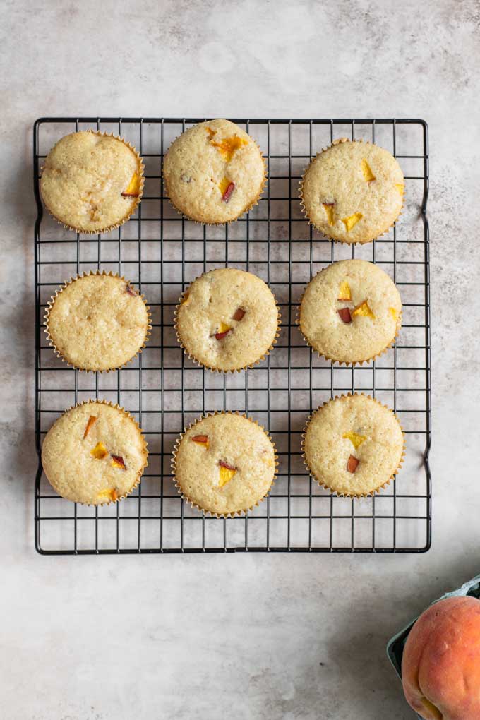 peach cupcakes on cooling rack