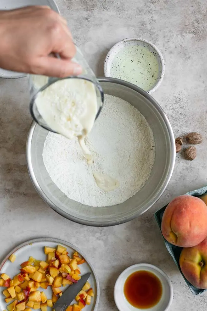 pouring vegan buttermilk into dry ingredients