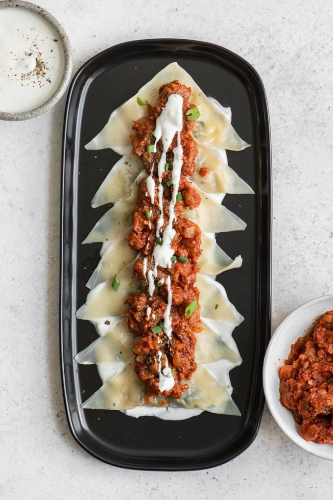 leek dumplings with vegan tomato meat sauce and garlic yogurt sauce