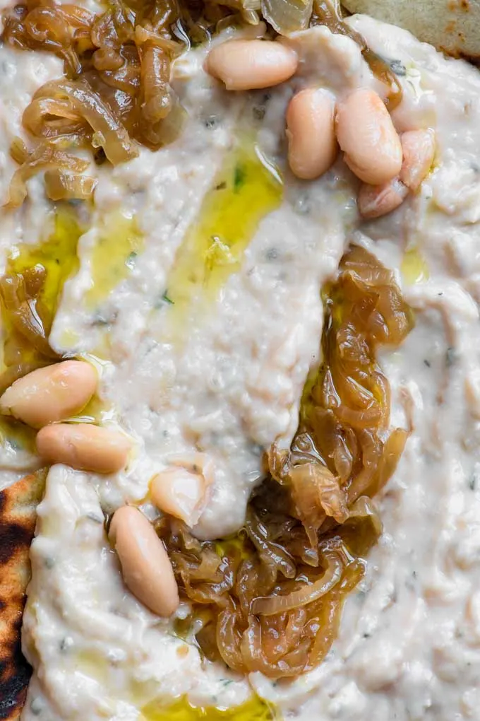 close up of caramelized onion white bean dip