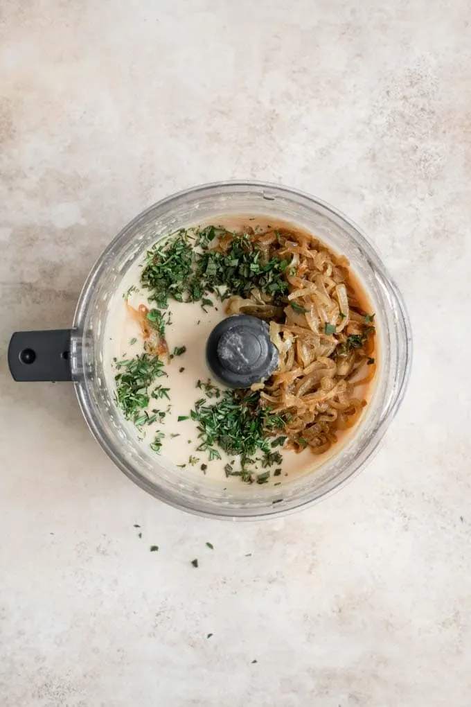 caramelized onions and herbs added to white bean dip in food processor