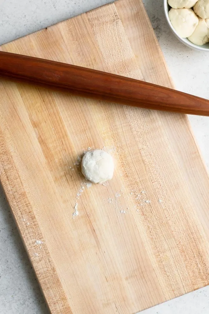 flour coated ball of dough before rolling out