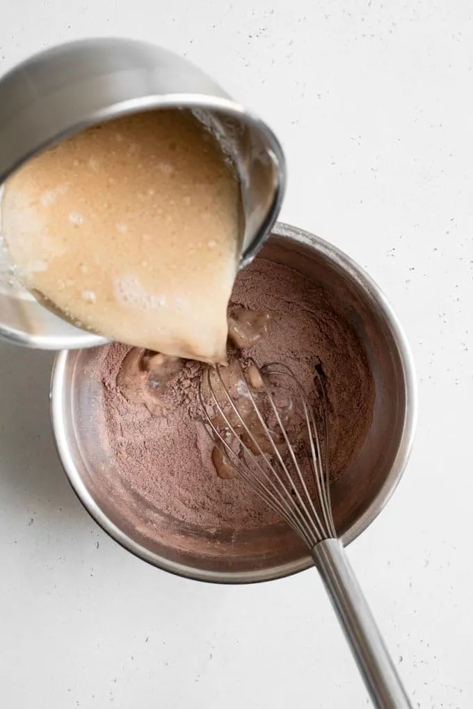 pouring liquids into dry ingredients for the cake batter