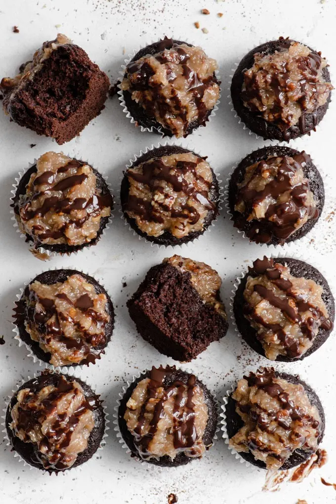vegan german chocolate cupcakes from above with two on their sides with bites taken out of them