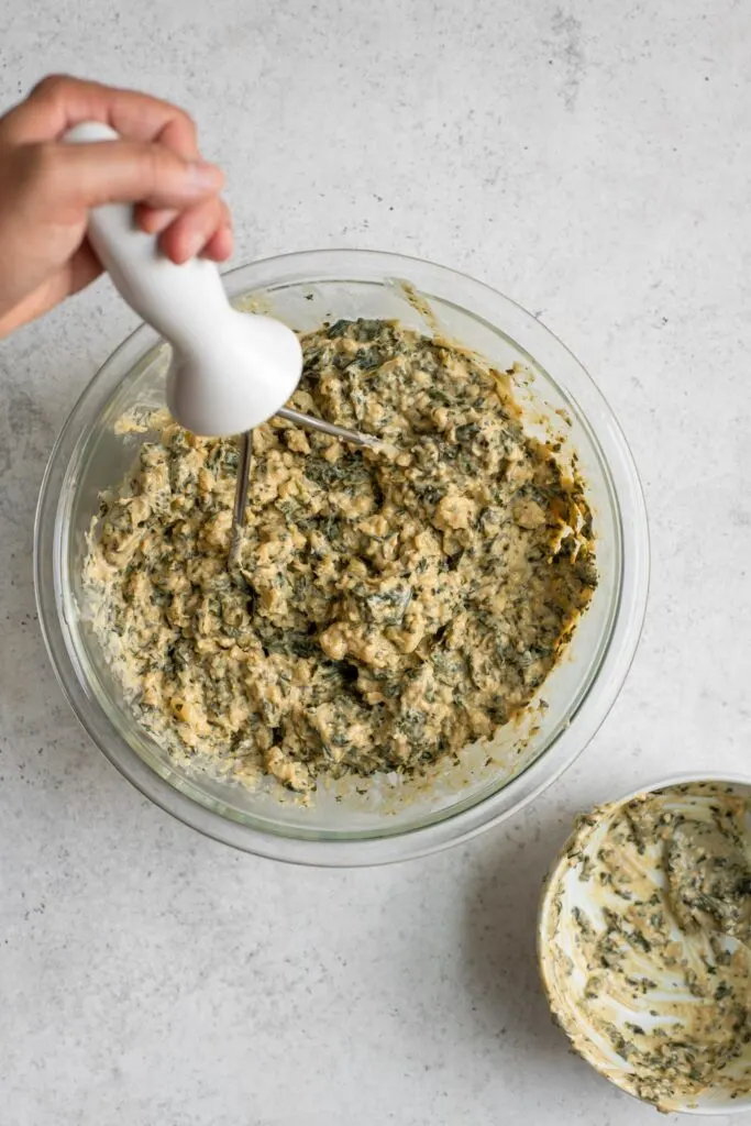 mashing potato and creamed collard greens together