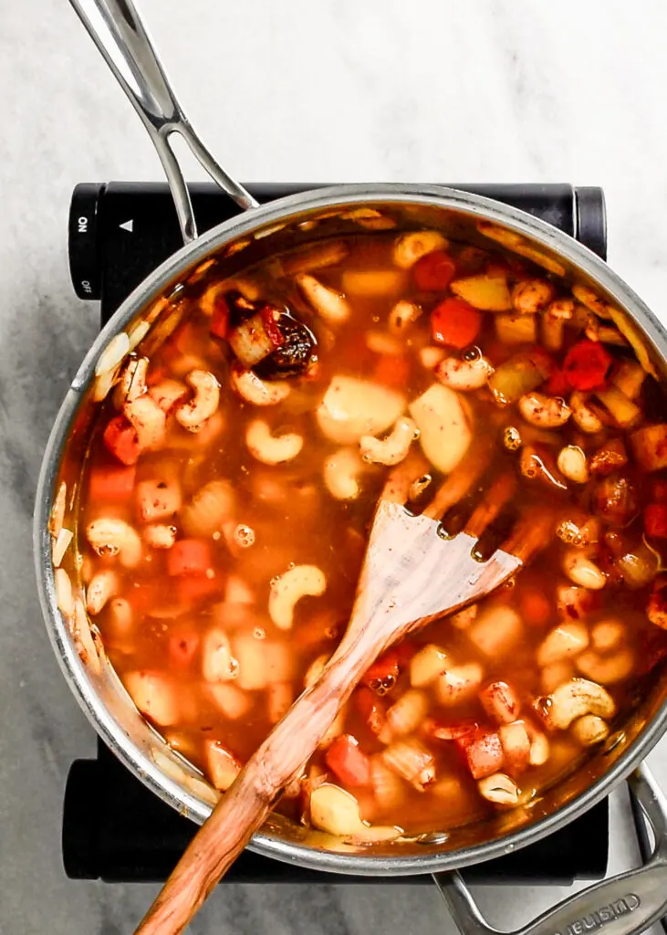 cooking the vegetables and cashews for the cheese sauce