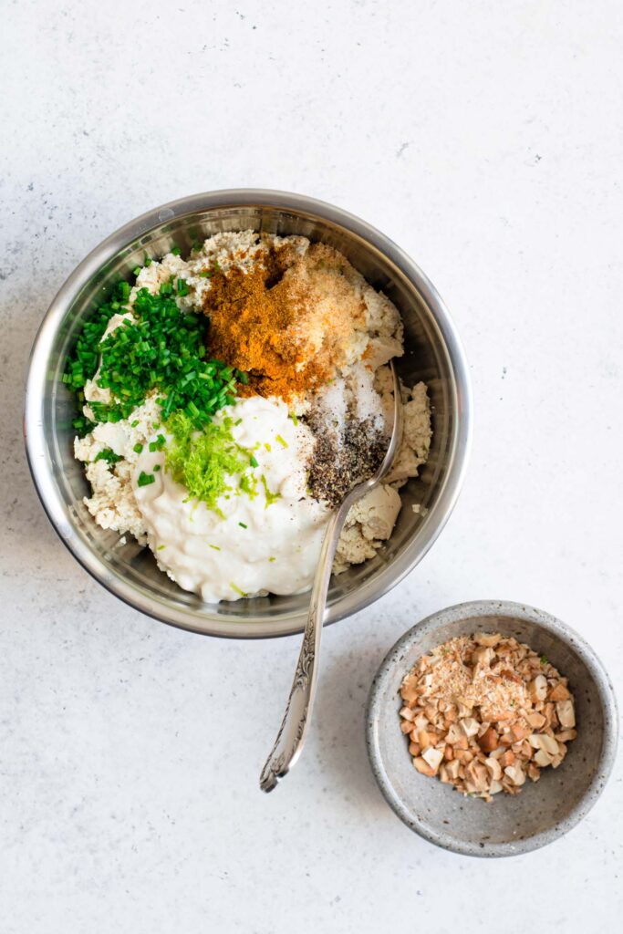 tofu crumbled in mixing bowl with the ingredients added on top