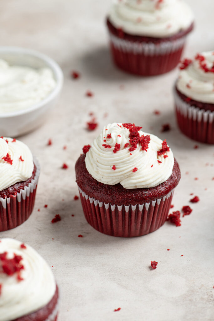 vegan red velvet cupcakes with a bowl of ermine frosting
