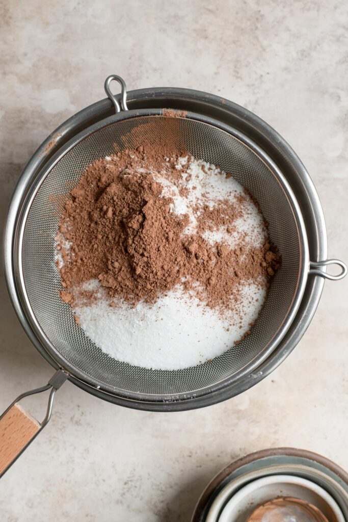 sifting dry ingredients into large mixing bowl