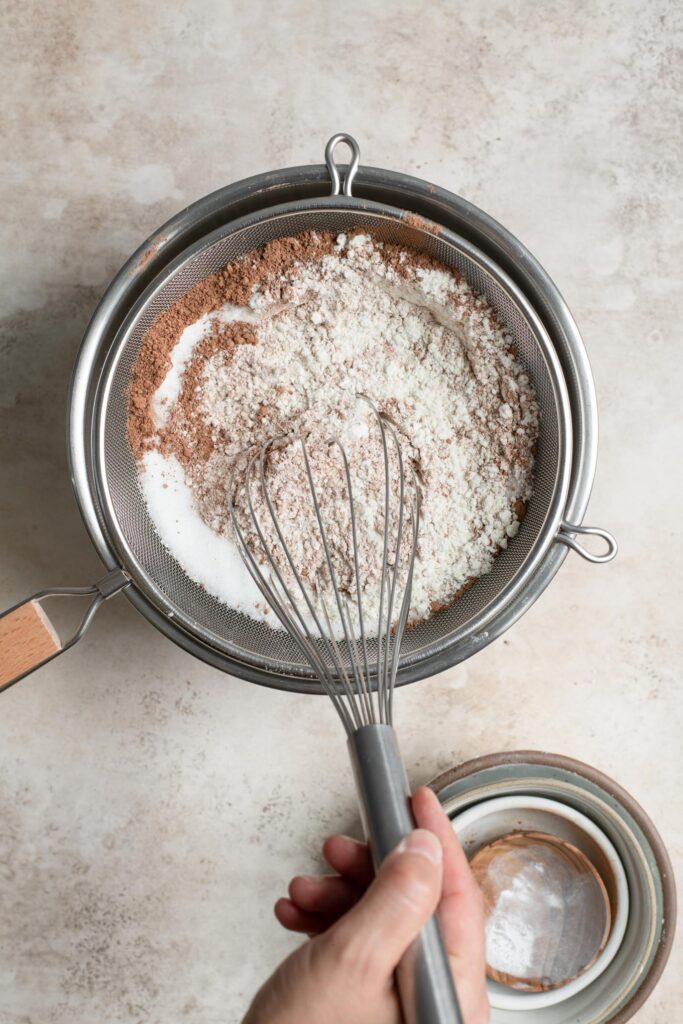 whisking dry ingredients through wire strainer