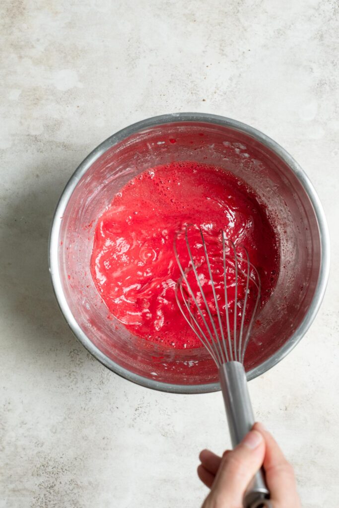 red food coloring mixed into wet ingredients to make a vibrant red color