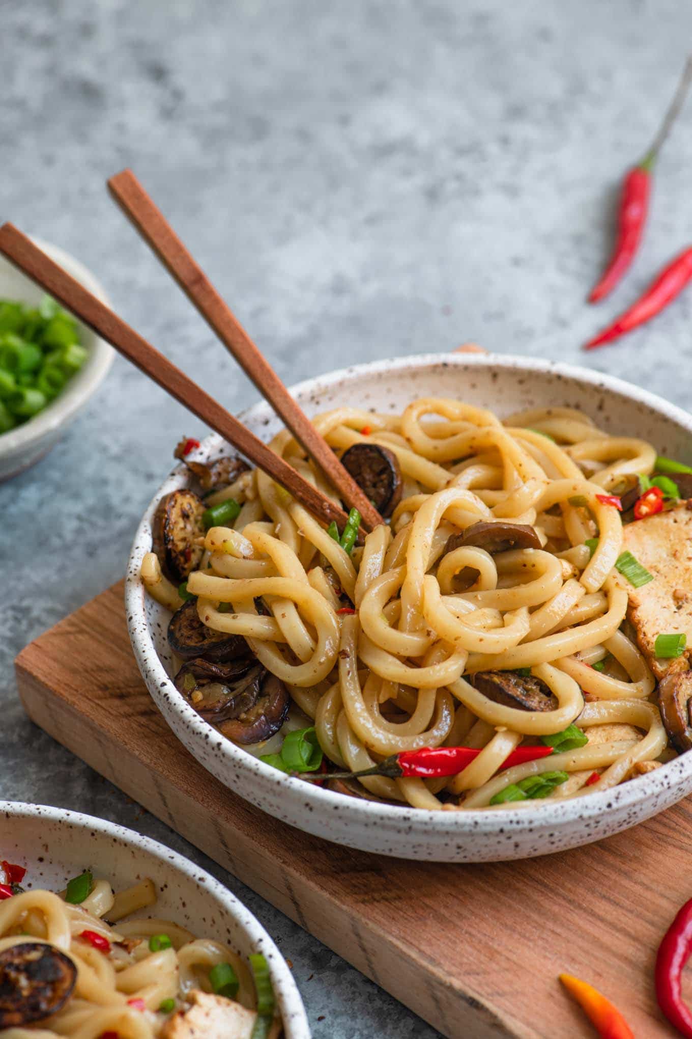 spicy sichuan noodles with eggplant in a bowl with wooden chopsticks