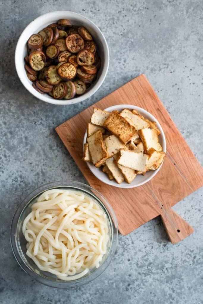 cooked eggplant, tofu, and noodles