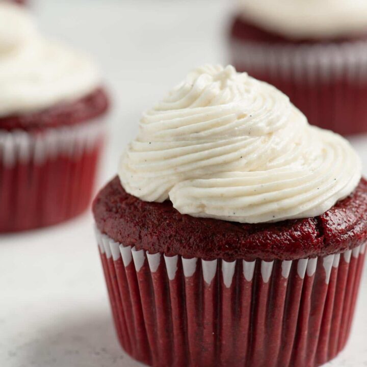 piped vegan ermine frosting on a red velvet cupcake
