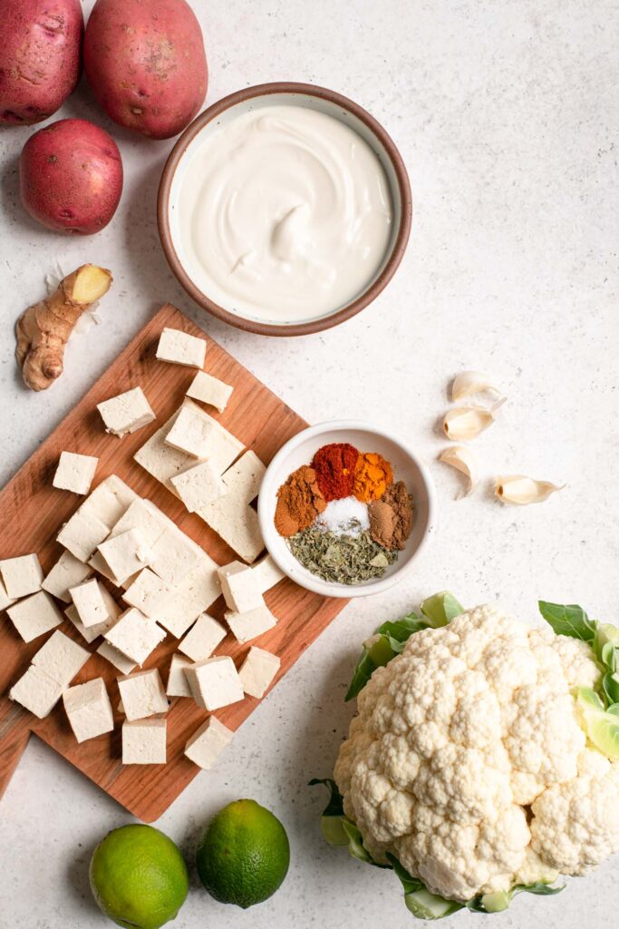 ingredients for tandoori (tofu, potatoes, yogurt, ginger, spices, cauliflower, garlic, and lime)
