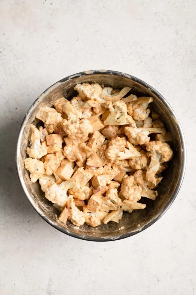 tofu, cauliflower, and potato coated in yogurt sauce