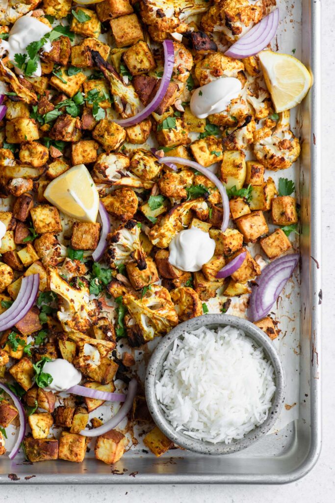 vegan tandoori sheet pan dinner with wedges of lime and basmati rice