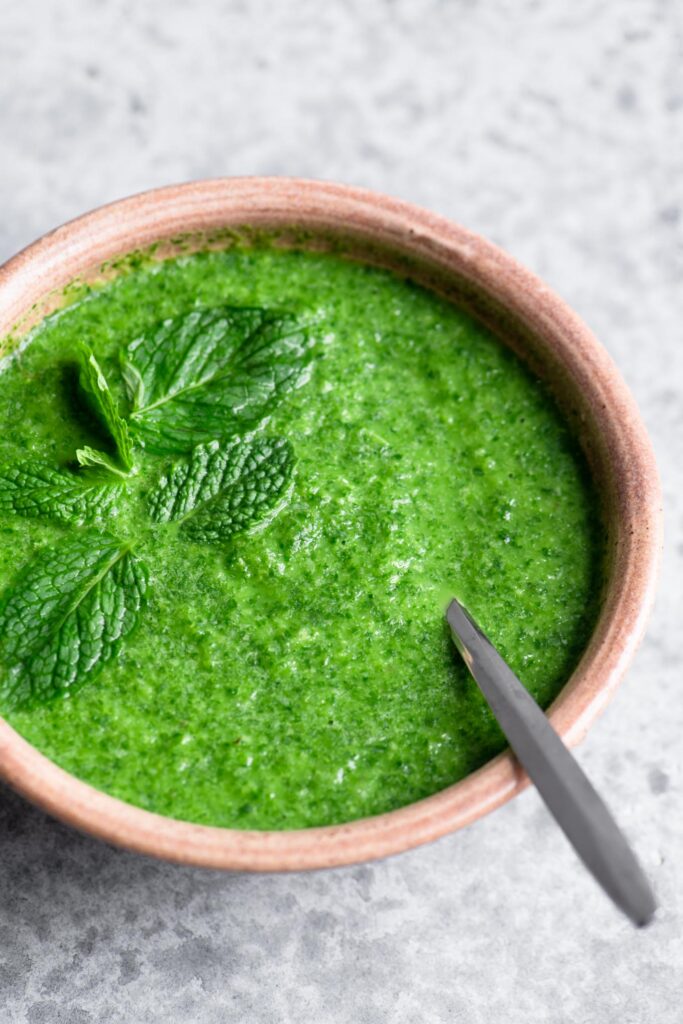 cilantro mint chutney in a bowl garnished with mint