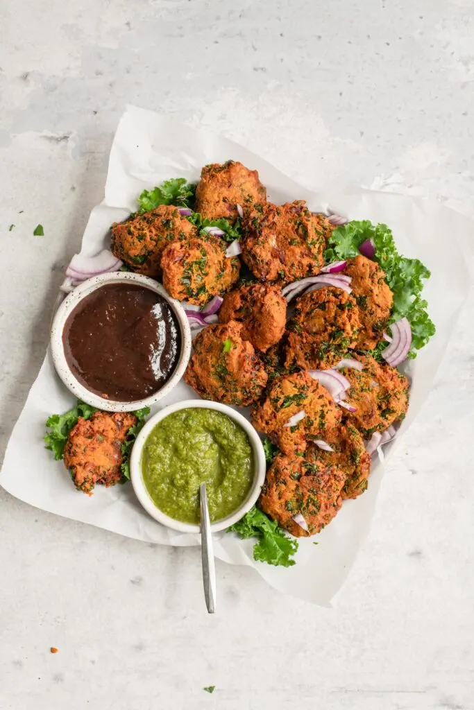 overhead view of kale pakoras and chutney